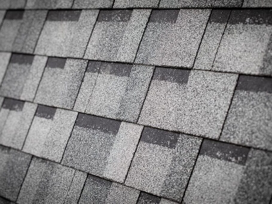 Close-up of installed architectural shingles showing layered dimensional texture