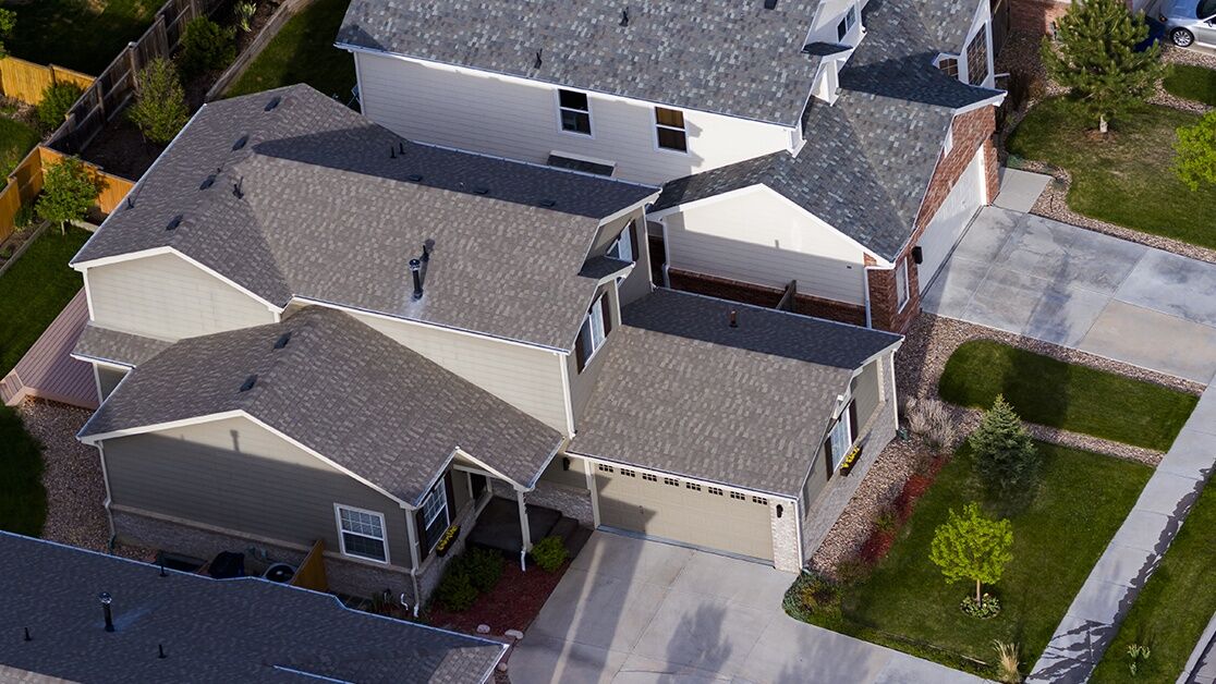 Suburban neighborhood showing houses of varying sizes with visible rooflines